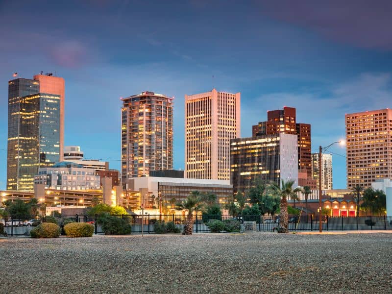 Downtown Phoenix skyline at dusk with high-rise buildings and desert landscape for Phoenix land surveying services