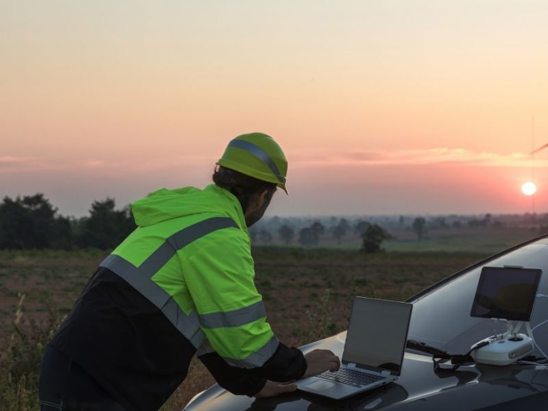 Survey professional using digital equipment in the field to provide accurate measurements for future property improvements.